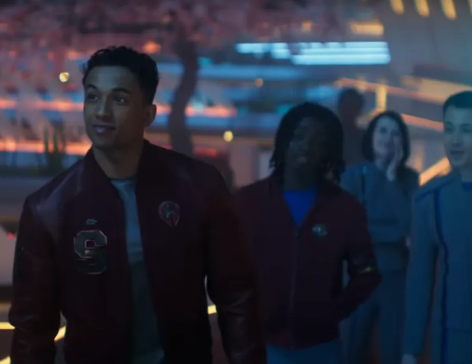 several Starfleet cadets, with a young man in the foreground wearing a varsity jacket