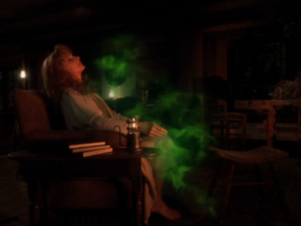 Beverly Crusher reclining in a chair as a strange green mist moves over her
