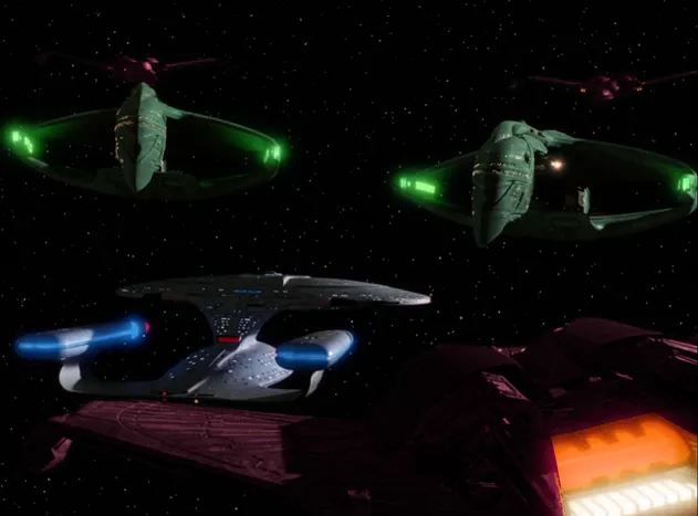 Three pink Klingon Birds-of-Prey, decloaking around the Enterprise-D and two Romulan warships