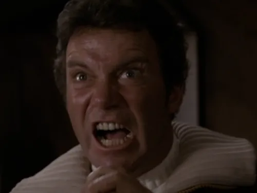 Kirk yelling into a handheld communication device