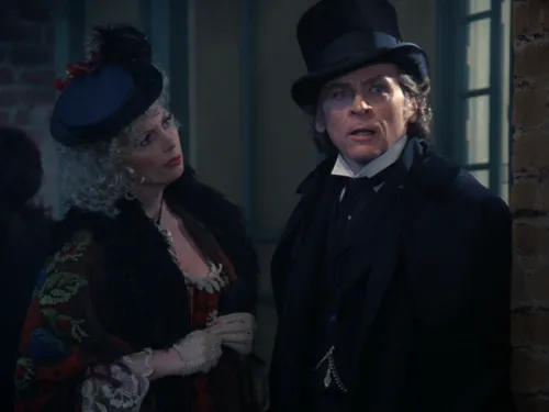 A woman looking curiously at Moriarty who is dressed in a suit and top hat