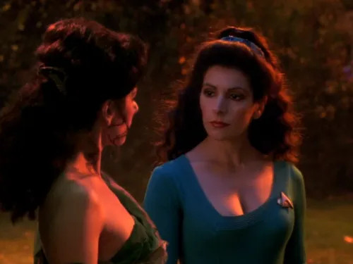 Counselor Troi standing next to a holodeck recreation of herself