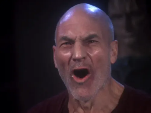 Picard, looking exhausted and with visible stubble, yelling