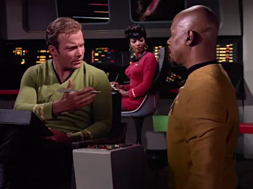 Sisko and Kirk conversing on the bridge of the original Enterprise while Uhura watches