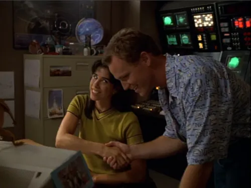 Tom Paris shaking hands with Rain Robinson in her astronomy lab
