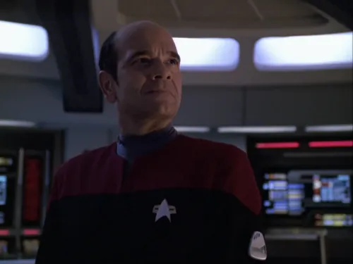 The Doctor on the bridge, wearing a red uniform and captain's pips