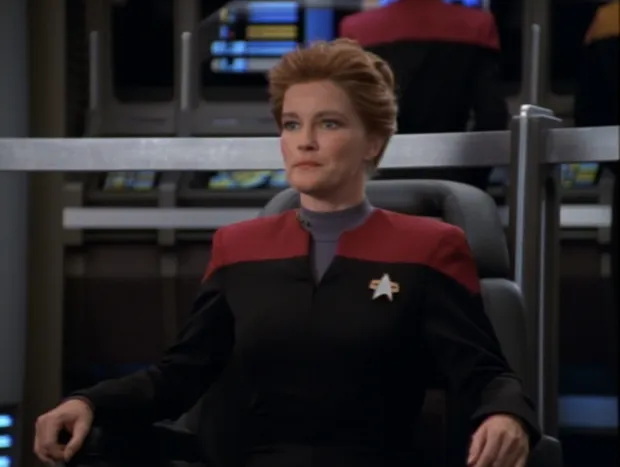 Janeway sitting in the captain's chair on the USS Voyager