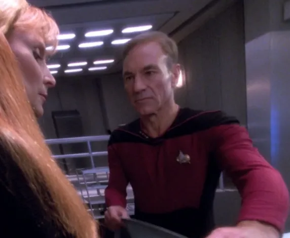 Picard lifting up a sheet to allow Beverly Crusher to identify her deceased husband, Jack
