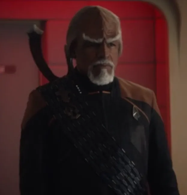 An aged Worf with white hair, eyebrows, and goatee, wearing a Starfleet uniform and a black baldric