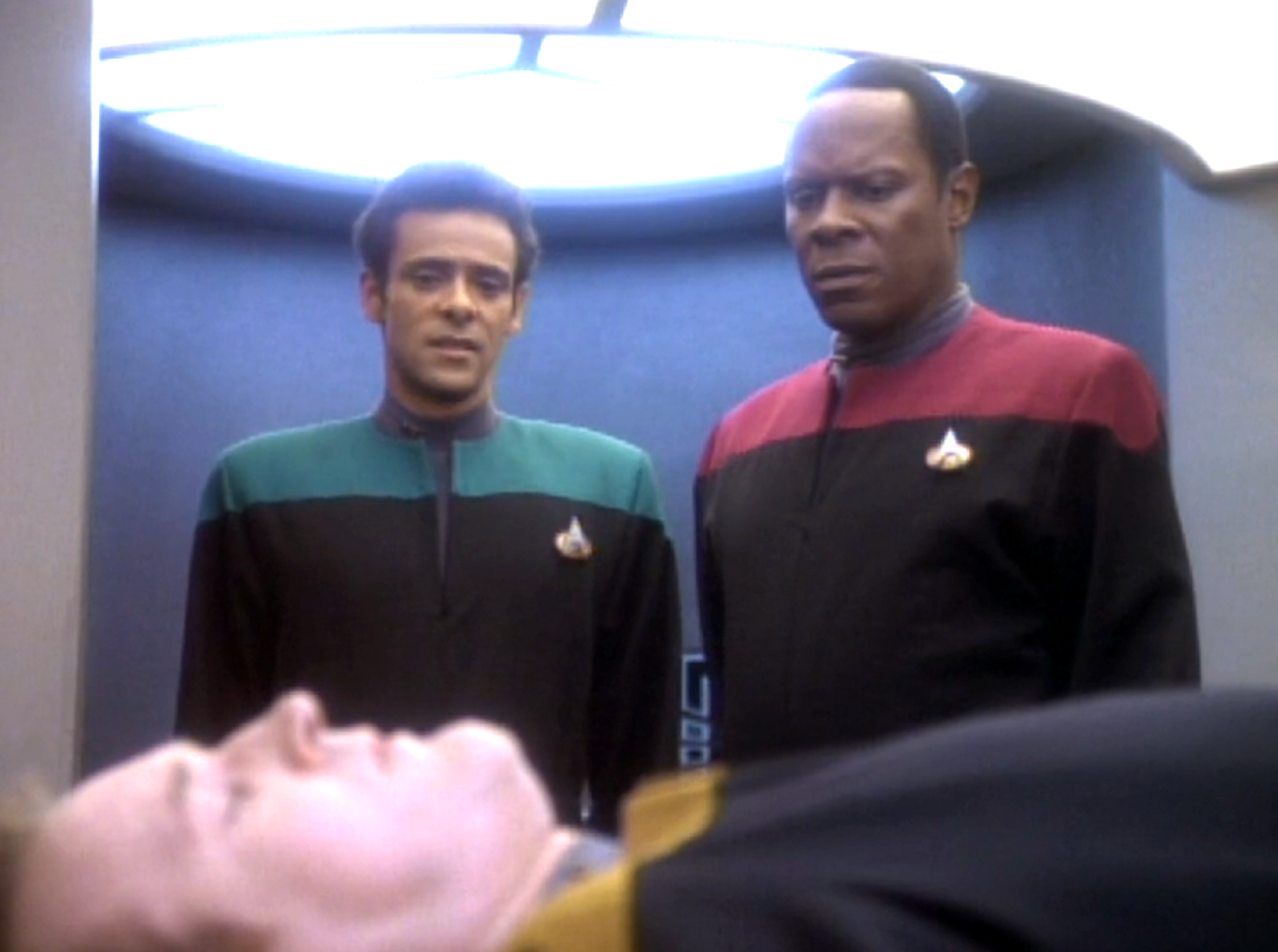 Bashir and Sisko observing an unconscious O'Brien in sickbay