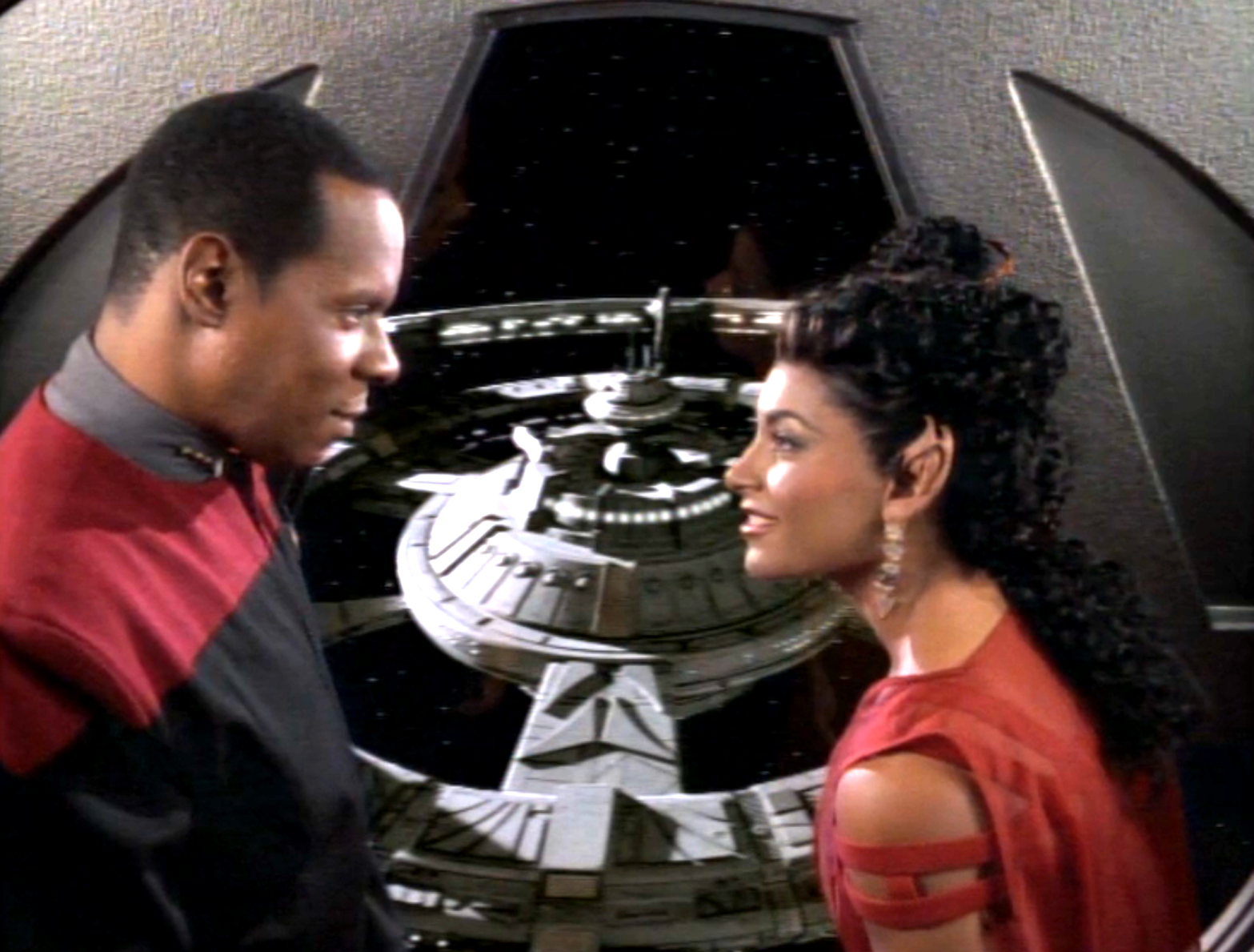 Sisko and a young woman enjoying a view of the station