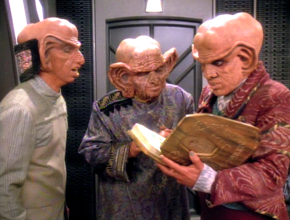 Quark, Rom, and the Grand Nagus reading from a large book