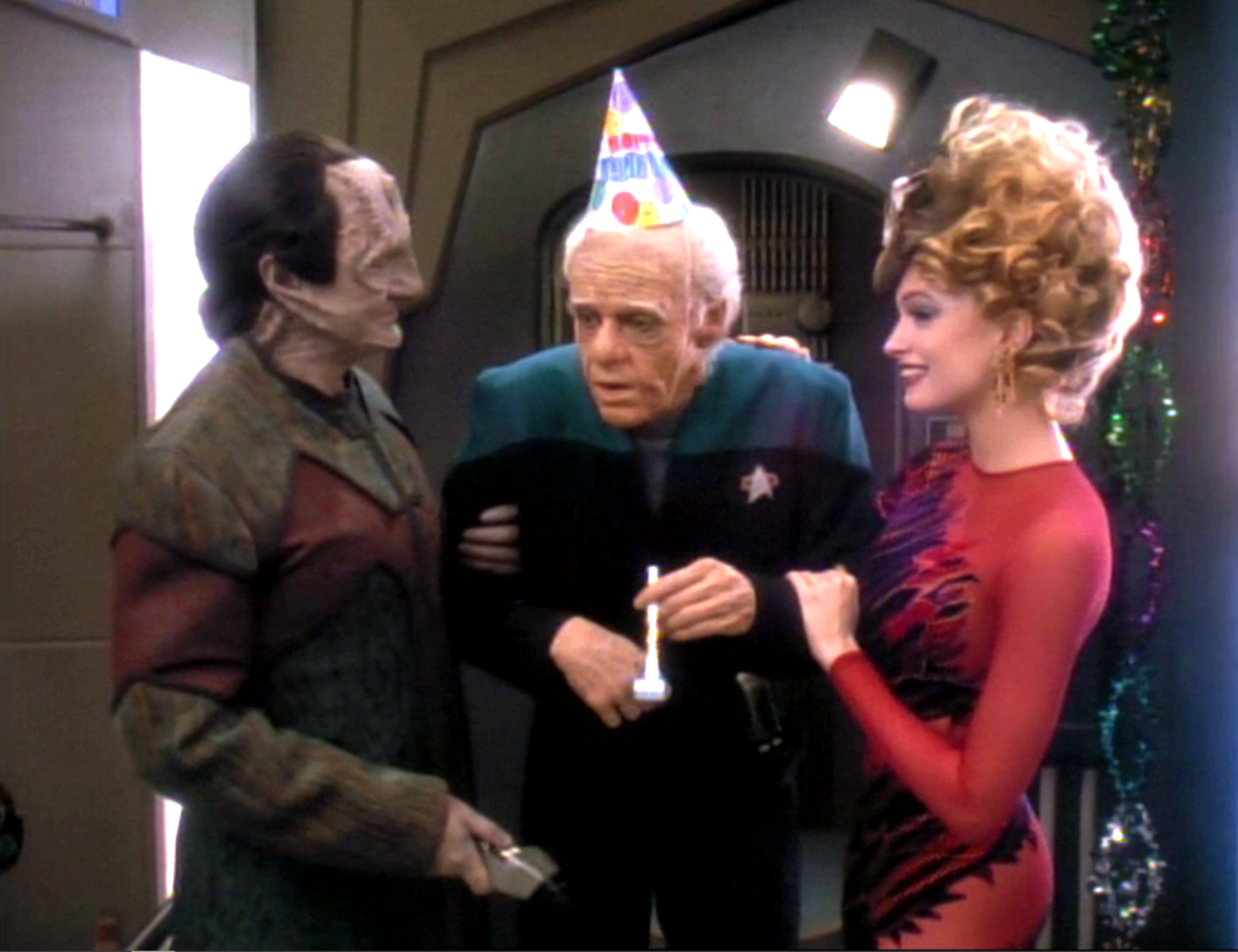 An aged Dr. Bashir talking with Garak and a dabo girl