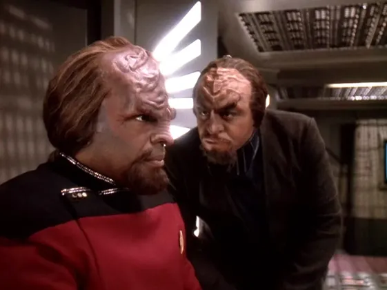 Worf, in his dress uniform, being questioned by another Klingon