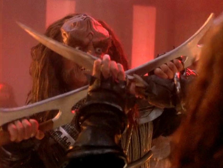 Gowron fighting someone with a bat'leth