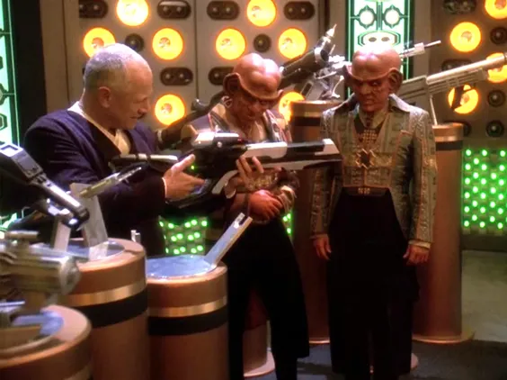 Quark, Gaila, and a third man testing several rifles
