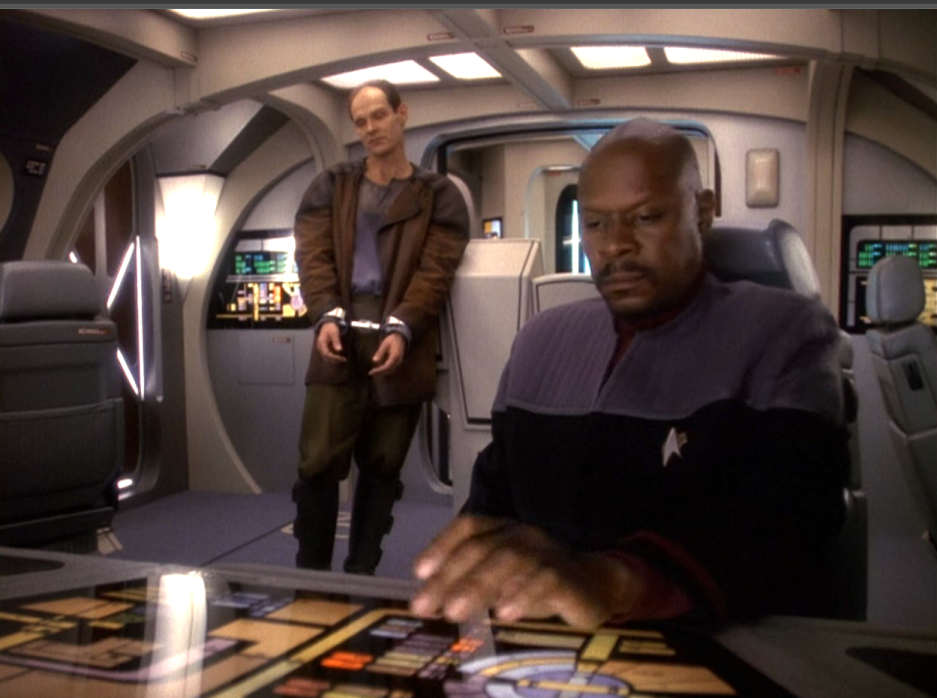 Sisko and a handcuffed Eddington talking in a runabout