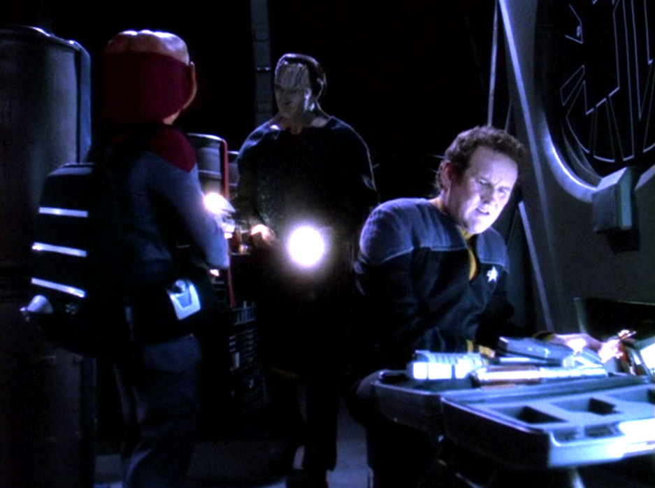 O'Brien, Garak, and Nog talking in a darkened room