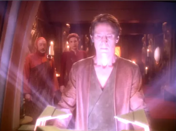 Bareil opening an orb ark while Kira watches from behind