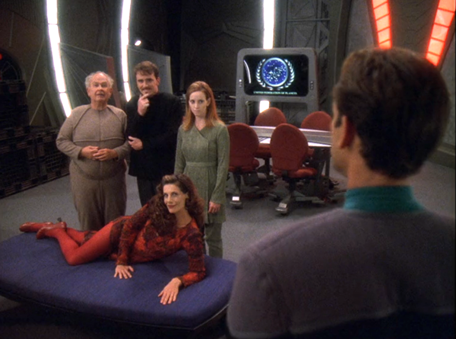 Two men and two women smiling at Dr. Bashir