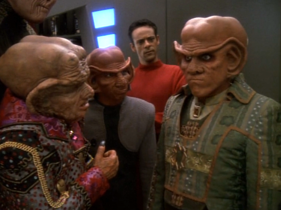 Quark appearing resolved while Zek, Rom, and Bashir look at him quizzically