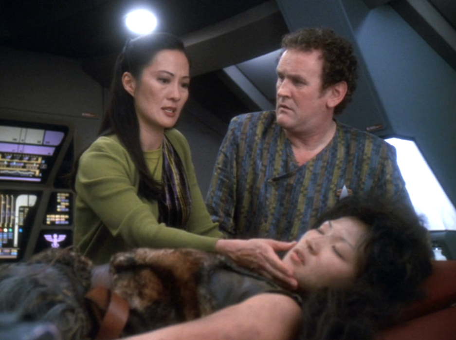 Miles and Keiko O'Brien caring for a primal-looking teenage girl