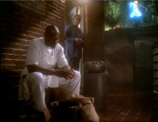 Sisko cleaning clams in an alley behind his father's restaurant