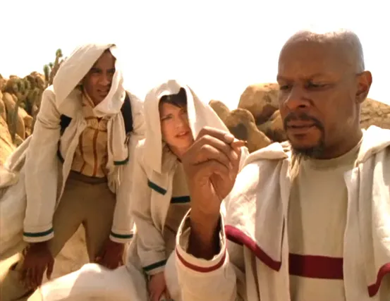 Sisko, in a desert with Jake and Ezri, looking confused at a pencil in his hand