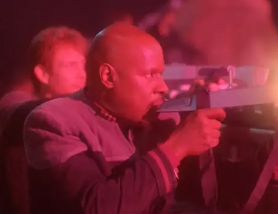 Sisko and another officer firing phasers from behind cover