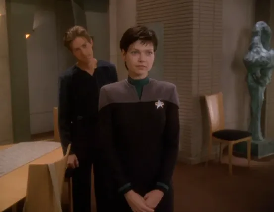 Ezri standing in her family's home