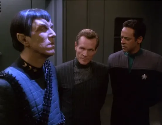 Bashir and Sloan discussing a hologram of a Romulan official