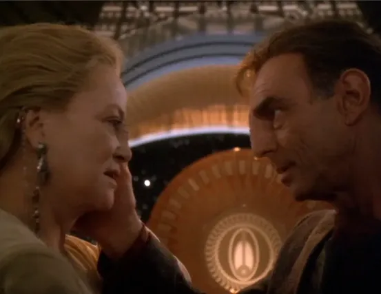 Winn and Dukat looking tenderly into each other's eyes