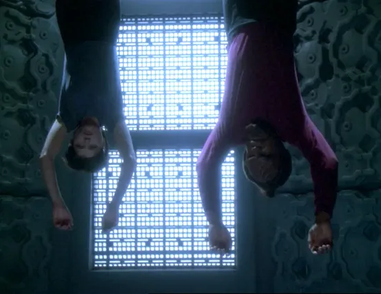 Ezri and Worf hanging upside down in a Breen prison cell