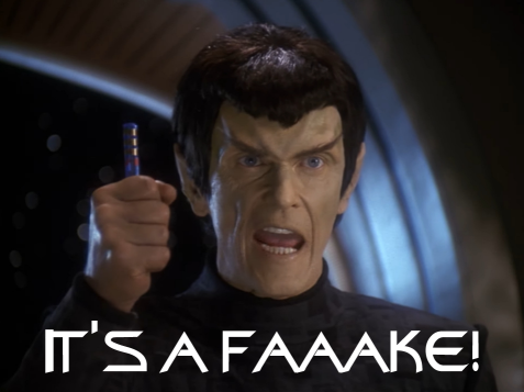 A Romulan holding a blue rod in his fist yelling, IT'S A FAKE!