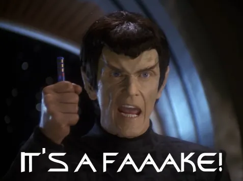 A Romulan holding a blue rod in his fist yelling, IT'S A FAKE!
