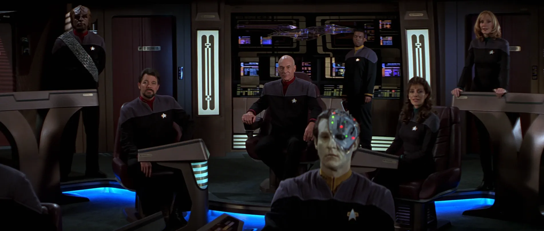 Picard, Riker, Worf, La Forge, Data, Troi, and Crusher on the bridge of the Enterprise-E