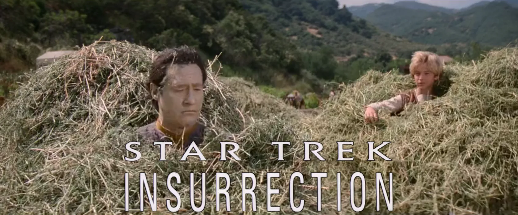Data and Artim playing in a large haystack