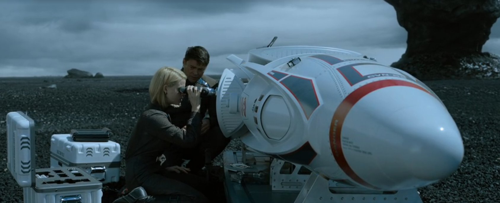 McCoy and Carol Marcus inspecting a long-range torpedo on the surface of an isolated planetoid