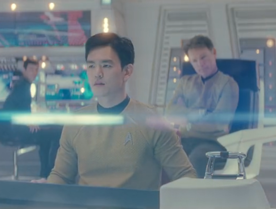 Pike and Sulu on the bridge as a large lens flare gives everything a bright white tint