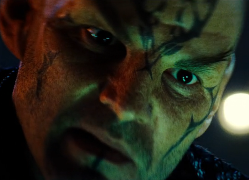 A close-up of Nero's tattooed face