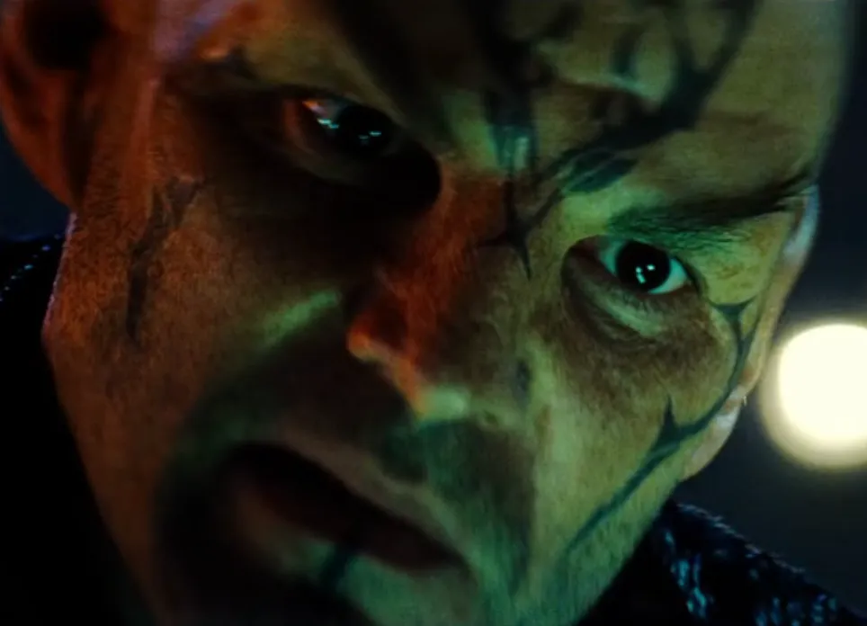 A close-up of Nero's tattooed face