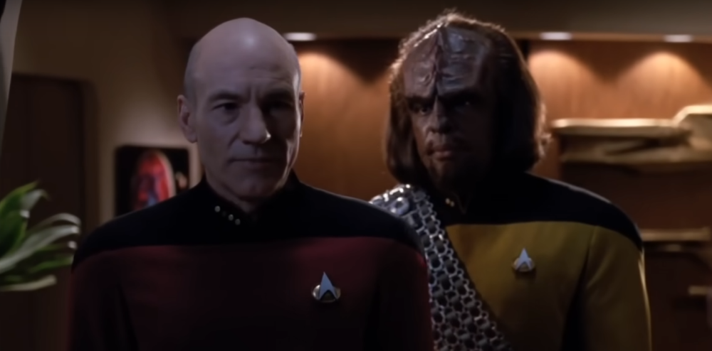 Captain Picard and Lieutenant Worf looking through the observation room windows on the Enterprise-D