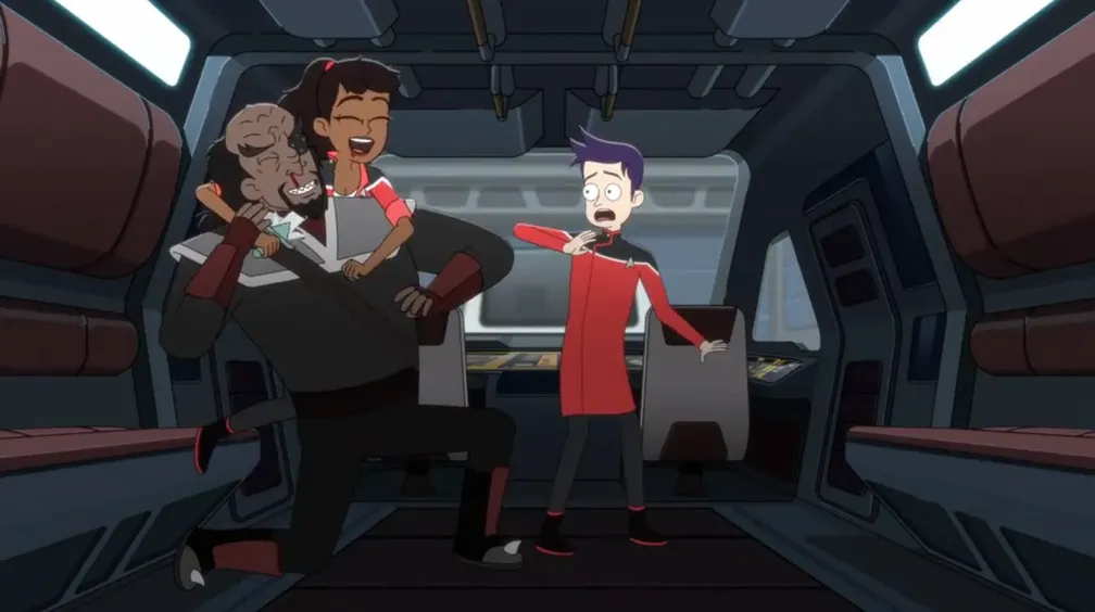 Boimler in a dress uniform looking on in horror as a laughing Mariner holds a knife to a laughing Klingon's throat