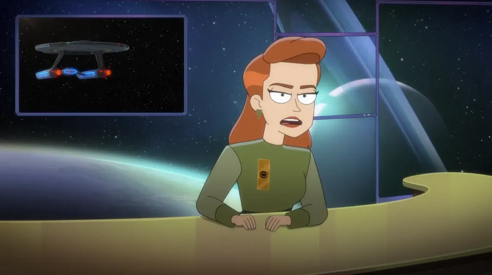 A woman sitting at a desk providing a newscast with an image of the Cerritos behind her