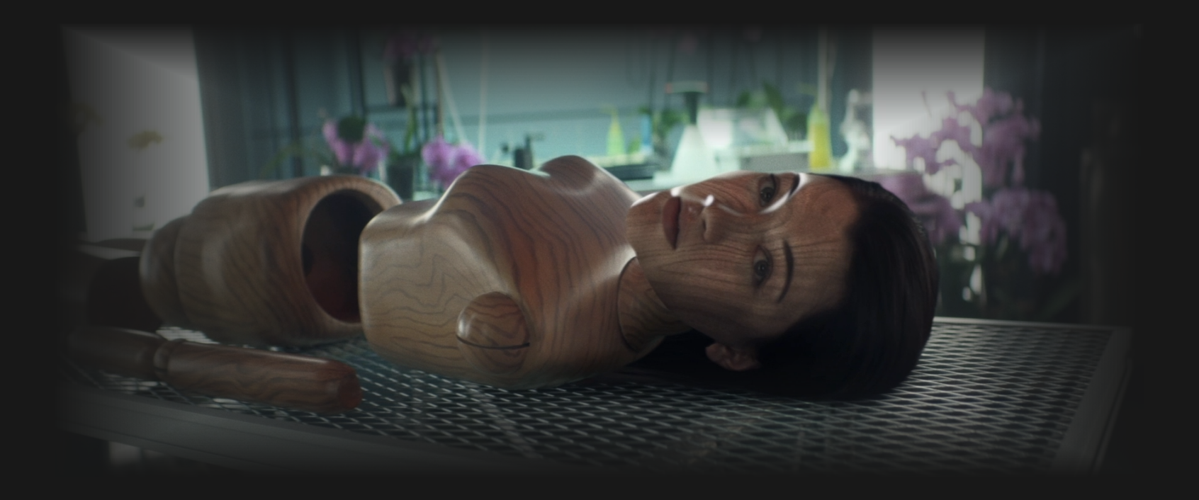 parts of a human-sized wooden doll lying on a table with Soji's face