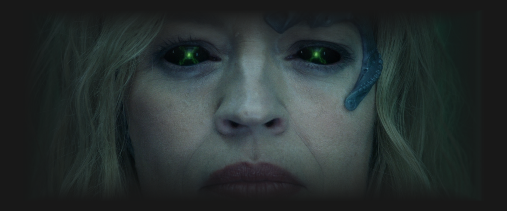 a closeup of Seven of Nine with green-glowing eyes