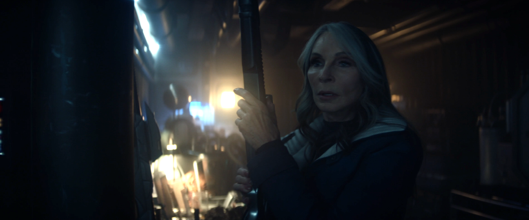 Beverly Crusher holding a phaser rifle