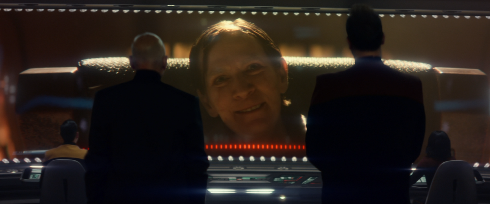 Picard and Shaw standing before the viewscreen where Vadic has appeared with a greeting