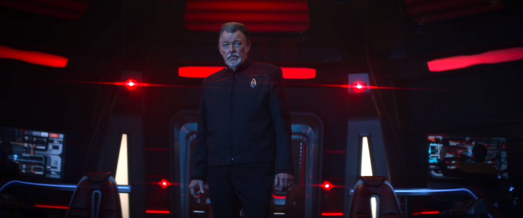 Riker standing on the bridge, in command of the Titan, which is at red alert