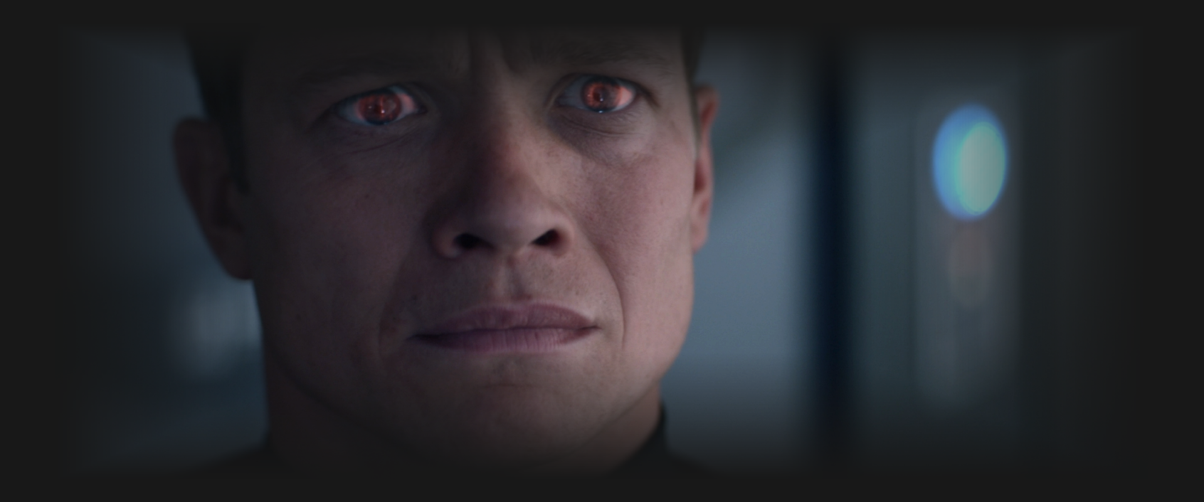 Jack Crusher looking concerned as a reflection of red light shines in his eyes